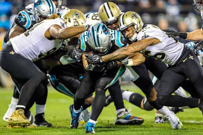 Carolina running back Christian McCaffrey (22) is wrapped up by the New Orleans Saints defense. Mandatory Credit: Jim Dedmon-USA TODAY Sports